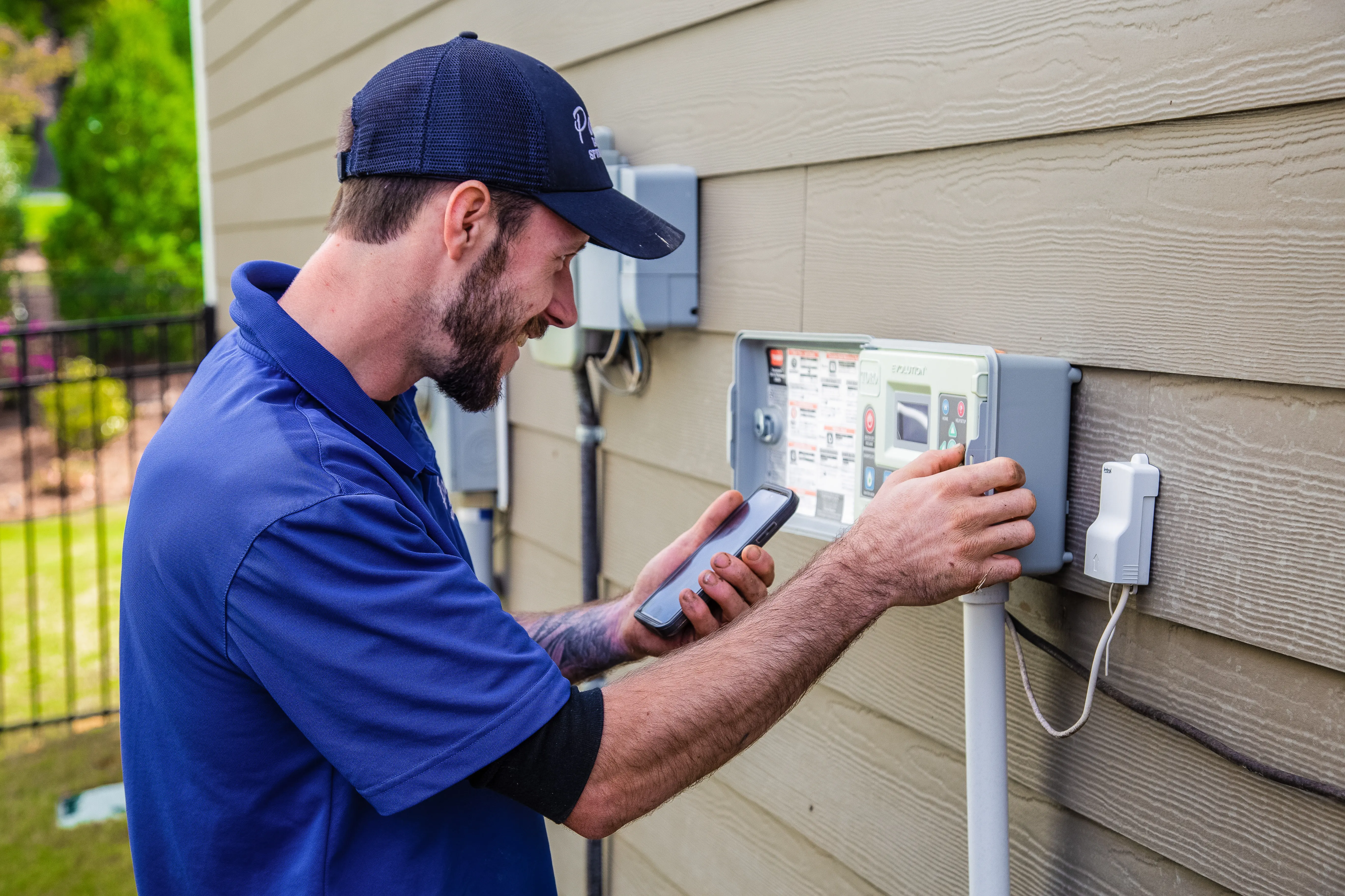 Technician diagnosing a sprinkler system