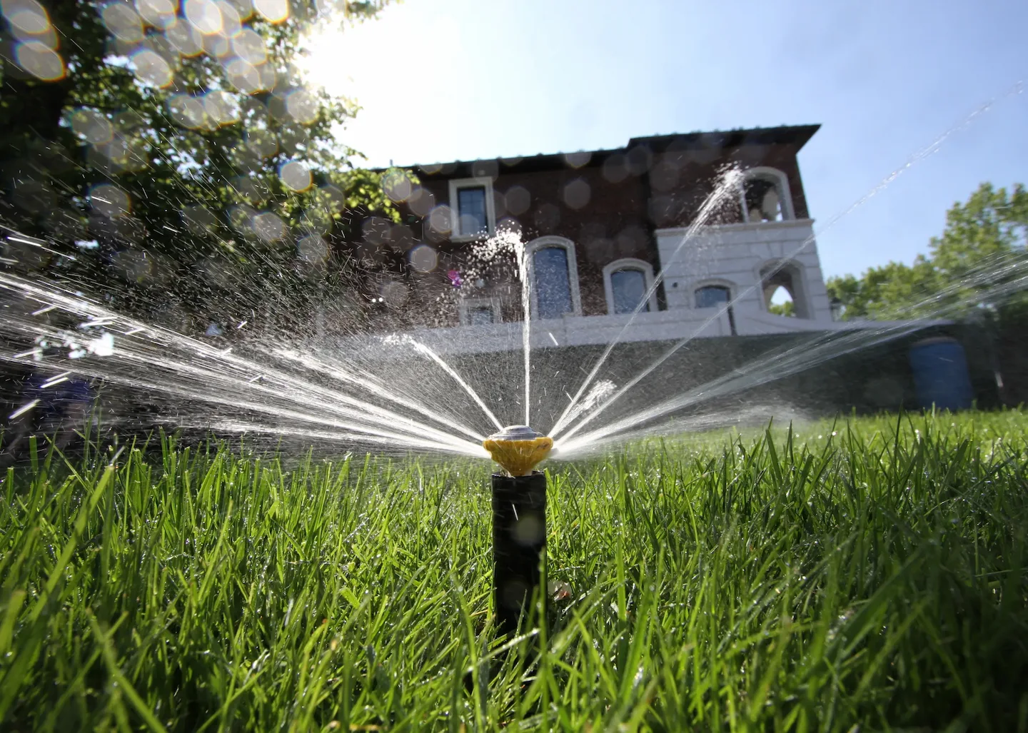Pacific Lawn Sprinklers technician servicing an irrigation system